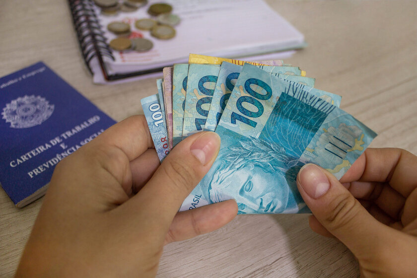 hand-holding-brazilian-moneywork-card-background-scaled.jpg