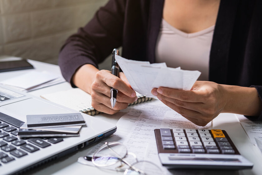 stressed-young-woman-checking-bills-taxes-bank-account-balance-calculating-expenses-living-room-home-scaled.jpg